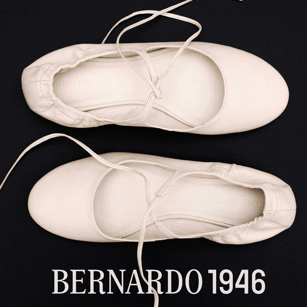 White Bernardo 1946 ballet shoe with laces on a black background